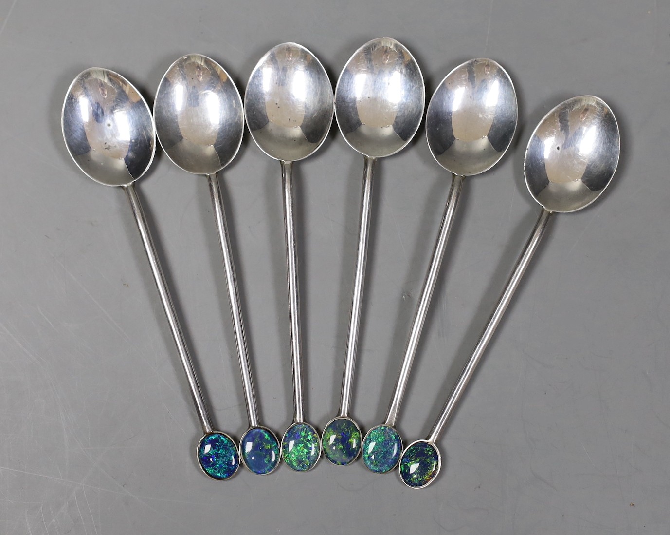 A set of six Australian sterling coffee spoons, with oval black opal doublet set terminals, 92mm.